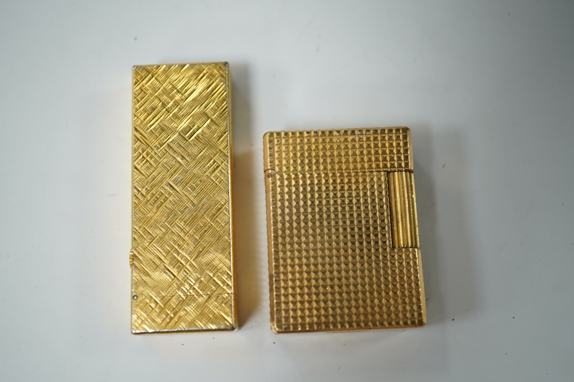 A cased DuPont lighter with booklet and a Dunhill rollagas example